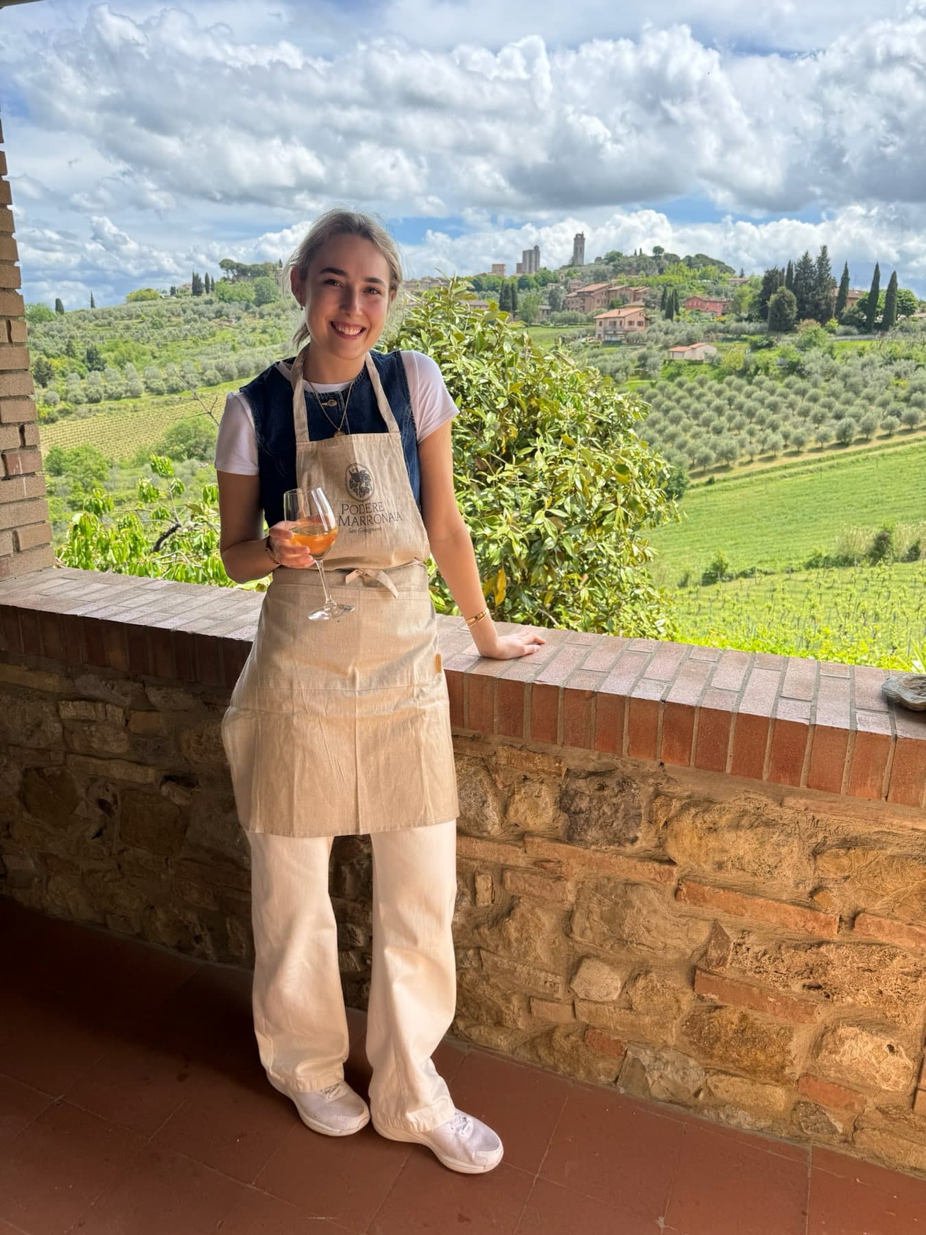 Annie wearing an apron at an outdoor cooking class
