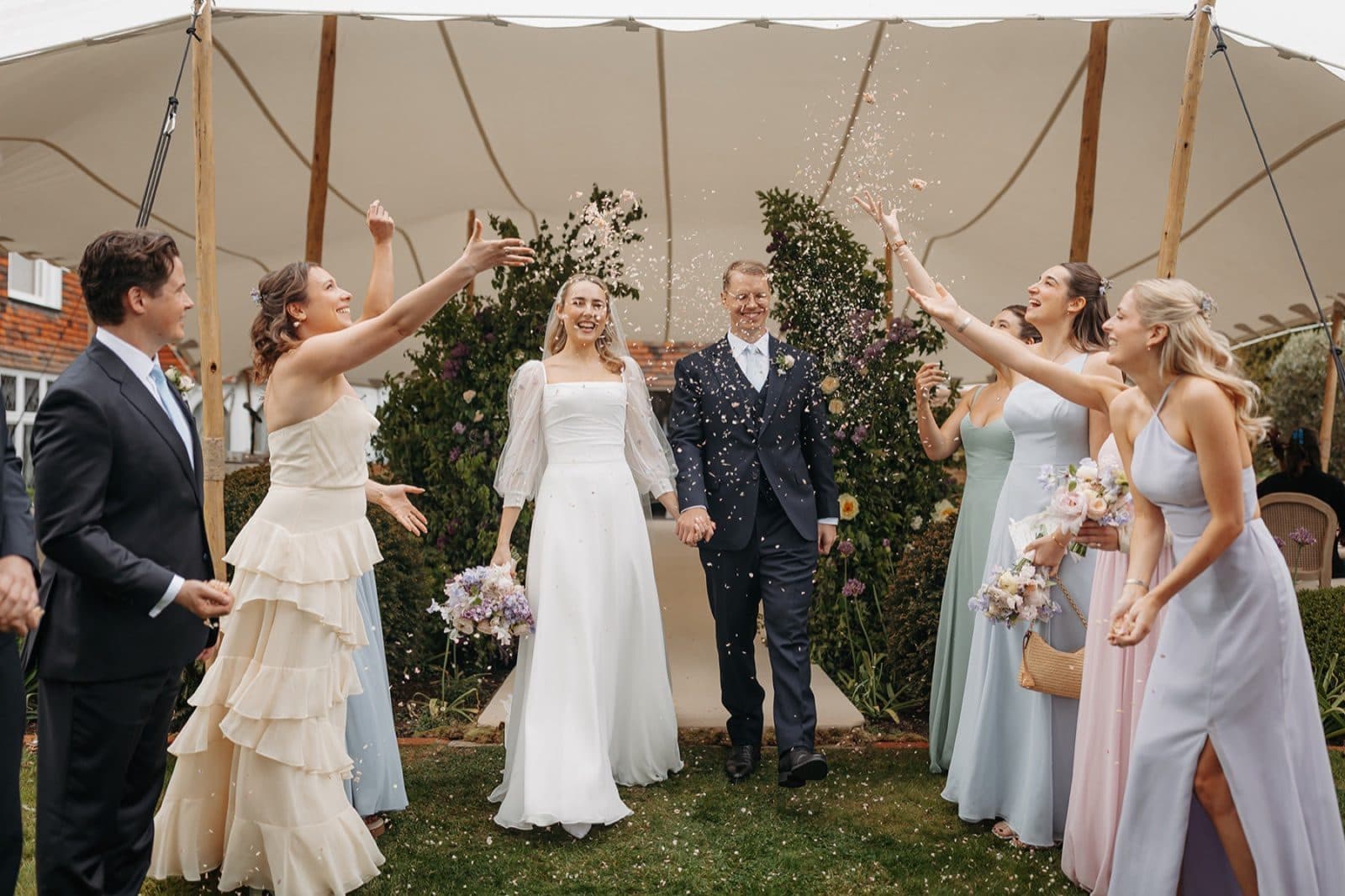 Annie and friends throwing confetti over a newly married couple